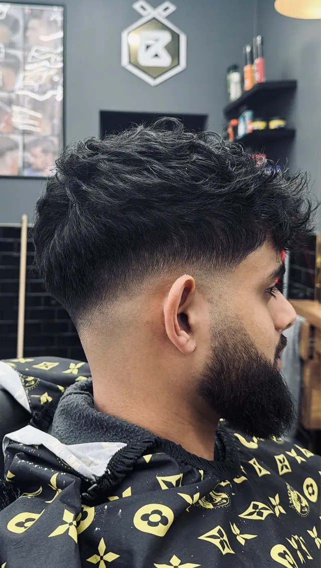 A textured fringe with a fade and a beard