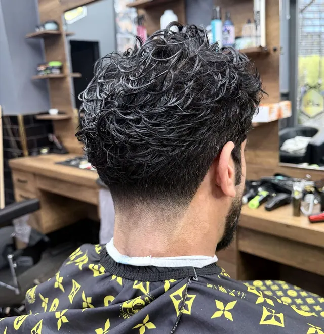 A curly cut with a taper